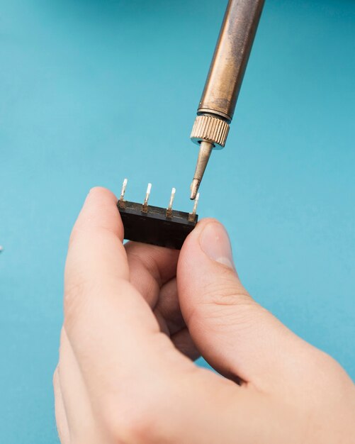 Using a soldering iron to repair a component