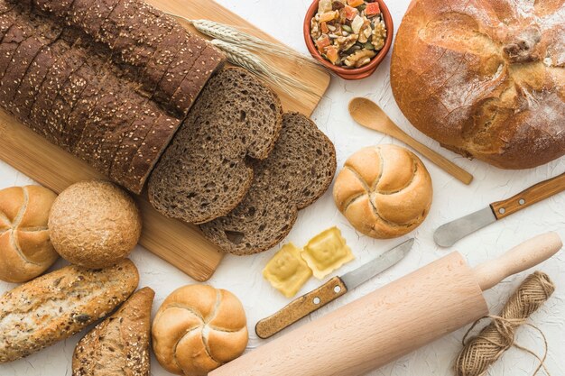 Utensils near bread and buns