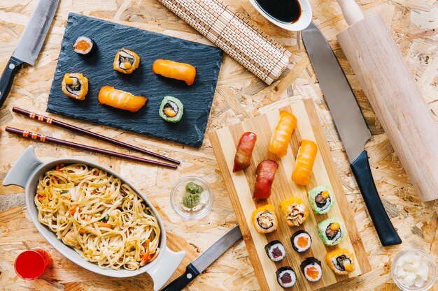 Utensils near sushi and noodles