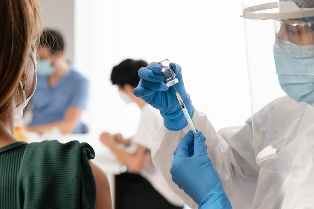 Vaccination center with doctor holding a syringe