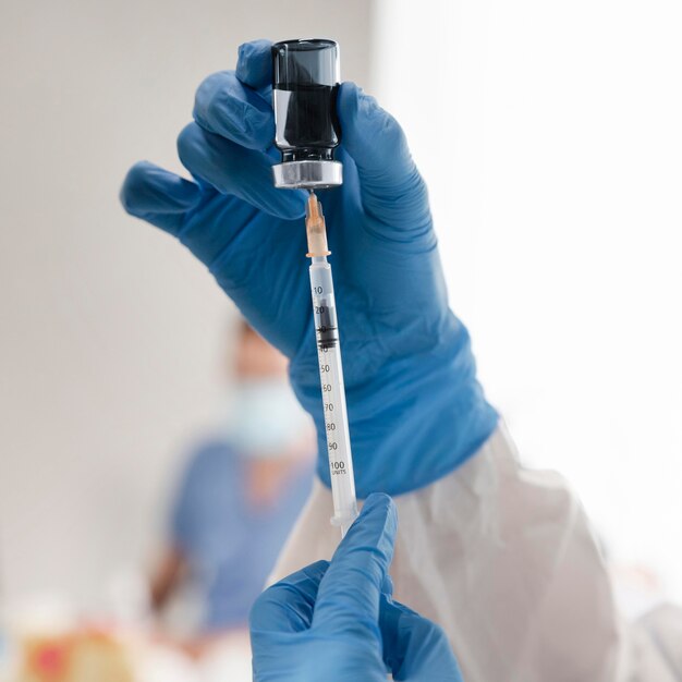 Vaccination center with doctor holding a syringe