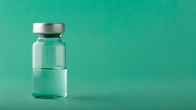 Vaccine bottle arrangement on green