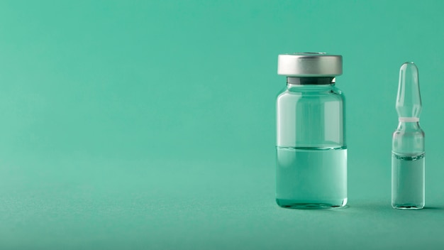 Vaccine bottle arrangement on green