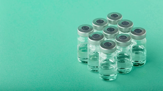 Vaccine bottle arrangement on green