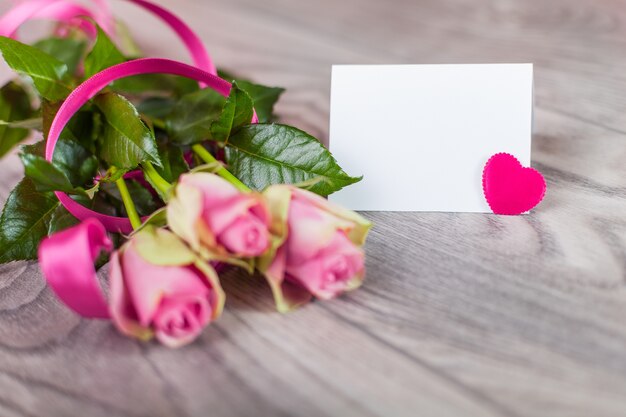 Valentine card with roses on wood