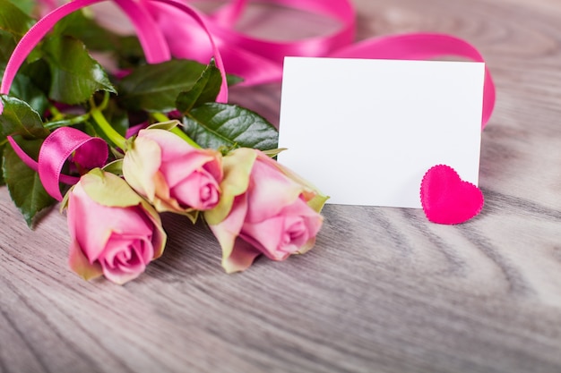 Valentine card with roses on wood