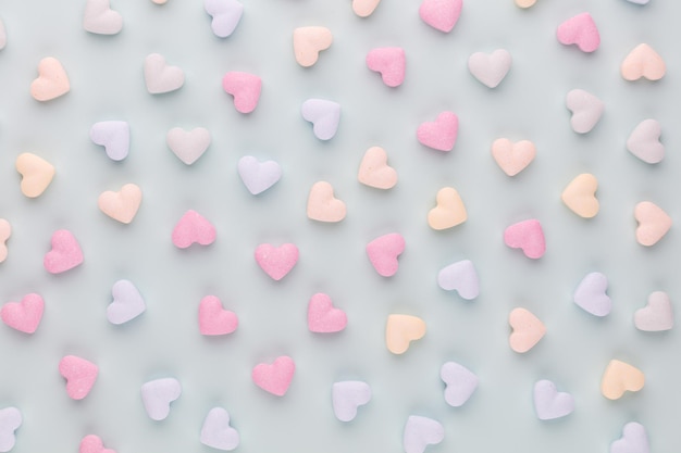 Valentine's day background. composition with candy hearts on pastel blue background. valentines day greating card. flat lay, top view.
