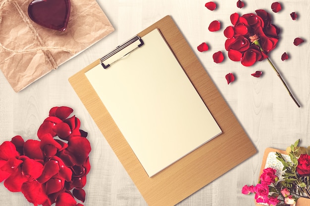 Valentine's Day composition with clipboard, present and candles