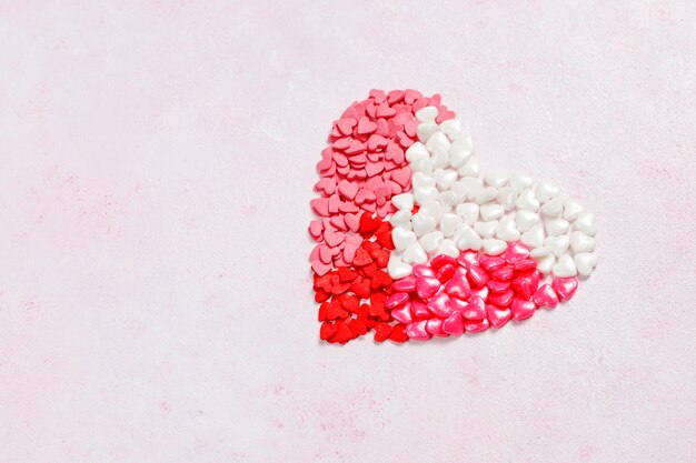 Valentines day background,heart shaped candies,sprinkles,top view