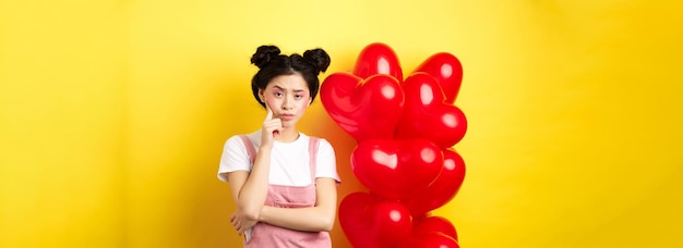 Free photo valentines day concept unamused and bored asian girlfriend staring skeptical at camera waiting for s