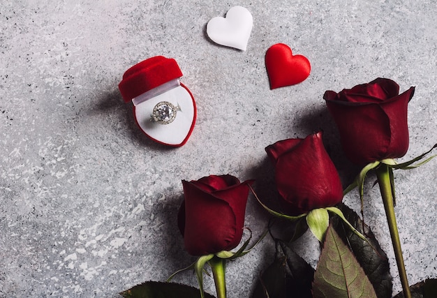 Free photo valentines day marry me wedding engagement ring in box with red rose gift
