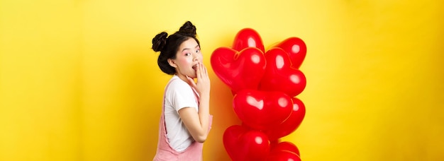 Free photo valentines day and relationship concept coquettish and romantic girl laughing covering mouth with ha