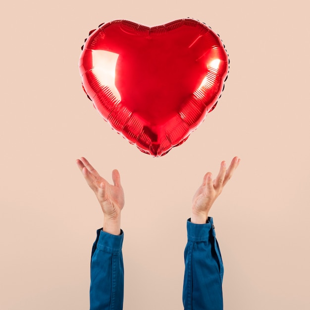 Valentines heart balloon held by a person