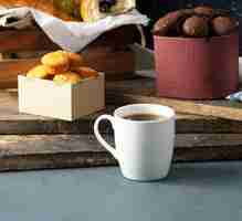 Free photo vanilla cookies and pralines with a cup of tea