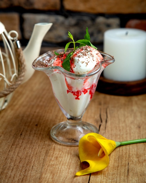 Vanilla ice cream with strawberry syrup garnished with grated chocolate