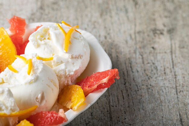 Vanilla icecream with watermelon and orange fruit pieces