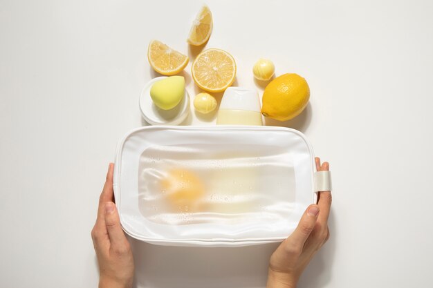 Free photo vanity case and citrus arrangement  flat lay