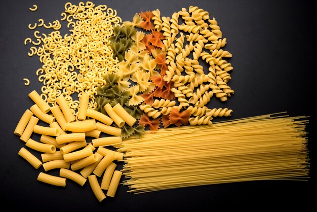 Variation of italian uncooked pasta over kitchen counter