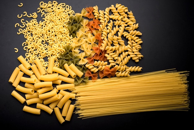 Variation of italian uncooked pasta over kitchen counter