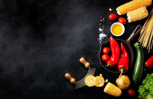 Varied vegetables placed on a black table