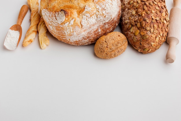 Varieties of bread with rolling pin