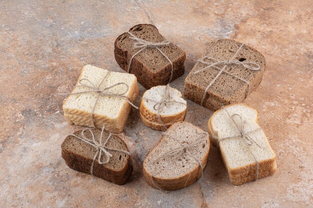 Variety of bread stacks on marble background