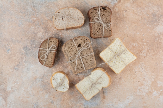 Variety of bread stacks on marble background