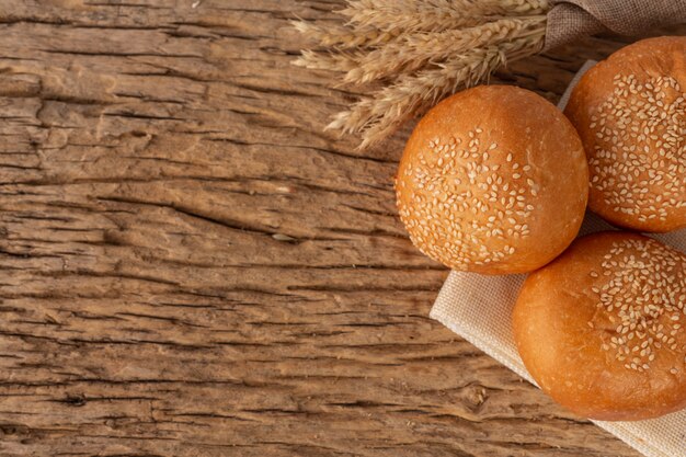 Variety of bread on wooden table on an old wooden background.