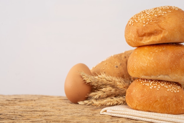 Variety of bread on wooden table on an old wooden background.