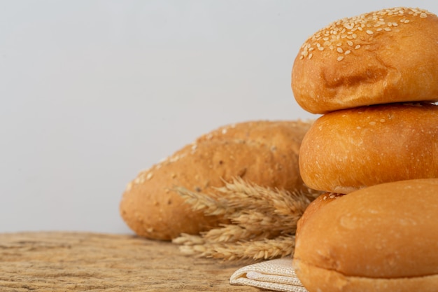 Variety of bread on wooden table on an old wooden background.