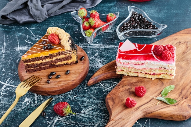Variety of cake slices on wooden board. 