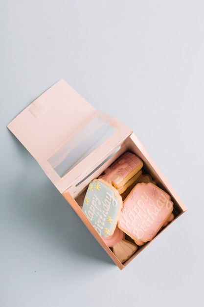 Variety of cookies with happy birthday text in gift box isolated on white background