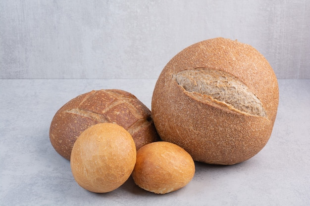 Variety of crusty bread on stone surface
