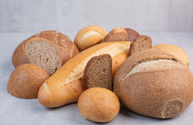 Variety of crusty bread on stone surface