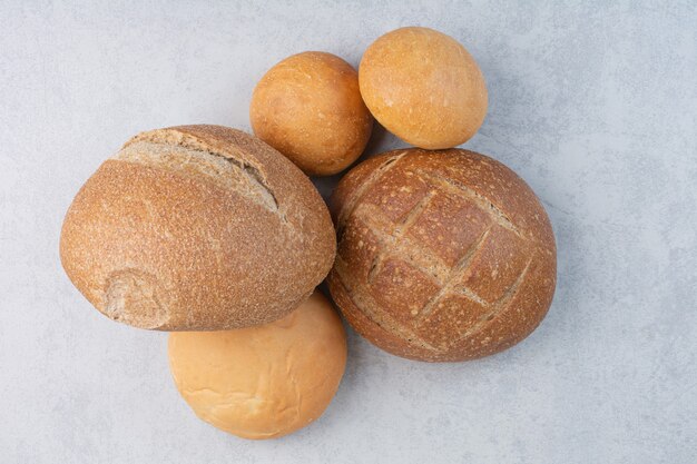 Variety of crusty bread on stone surface