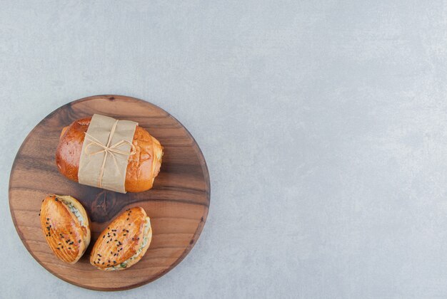 Variety of delicious pastries on wooden board. 