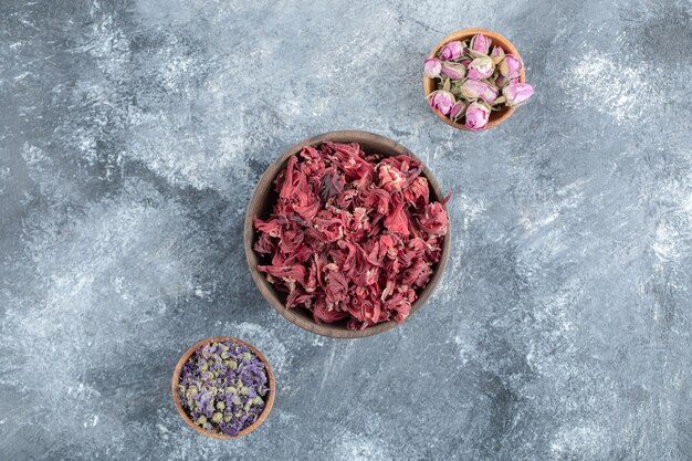 Variety of dried flowers in wooden bowls.