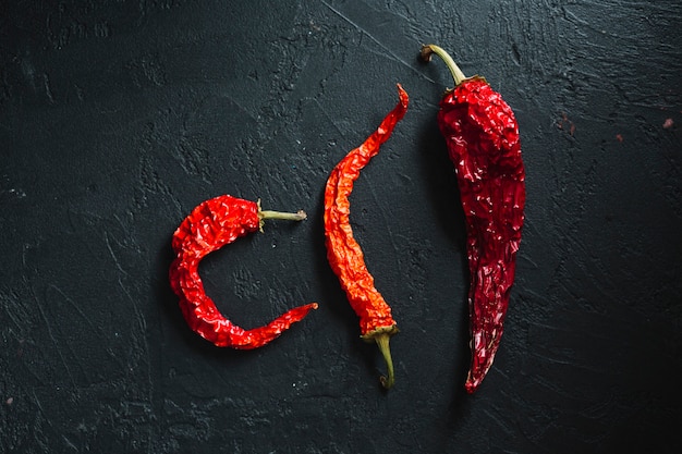 Variety of dried red hot chilli peppers top view