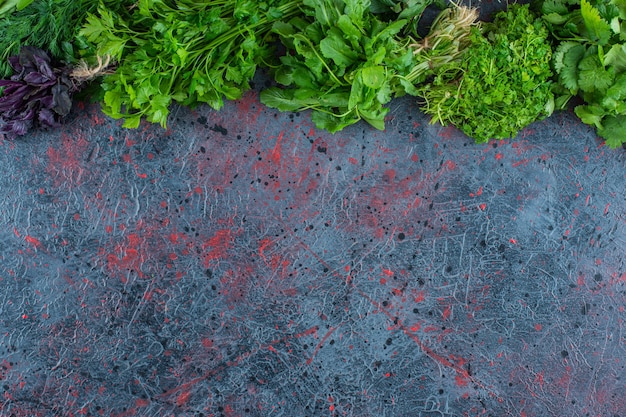 A variety of fresh greens, on the marble background. 