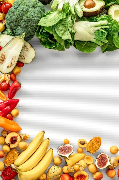 A variety of fresh vegetables and fruits on a white background flat lay