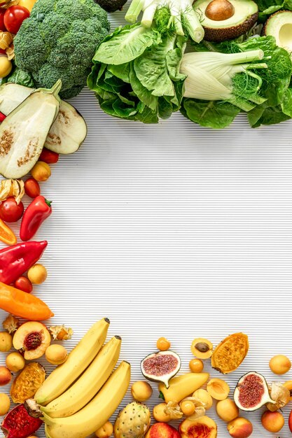 A variety of fresh vegetables and fruits on a white background flat lay