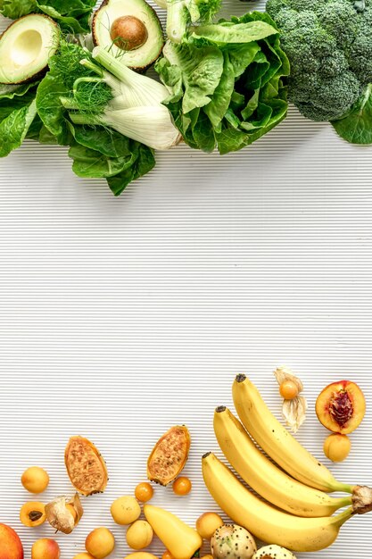 A variety of fresh vegetables and fruits on a white background flat lay