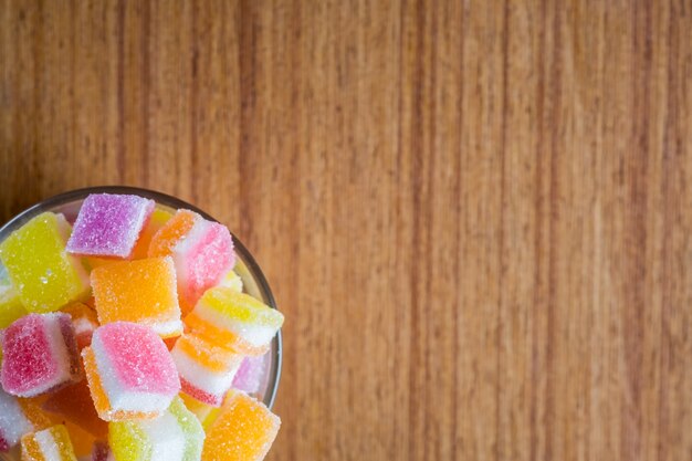 variety of gelly and candies on a wooden background