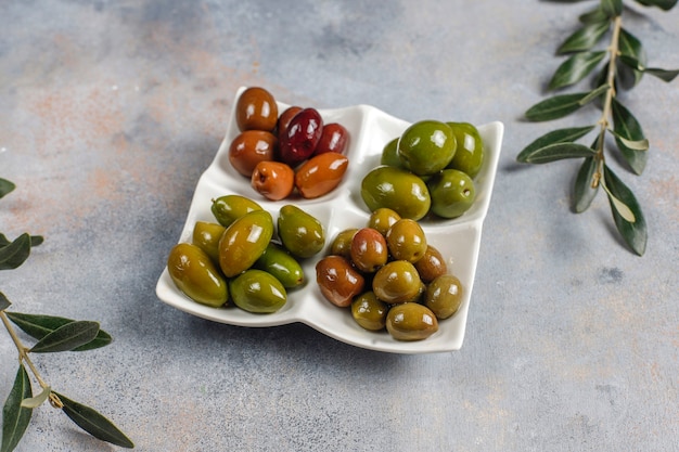 Variety of green and black whole olives.