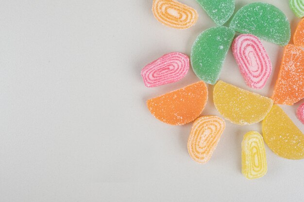 Variety of marmalade candies on beige surface