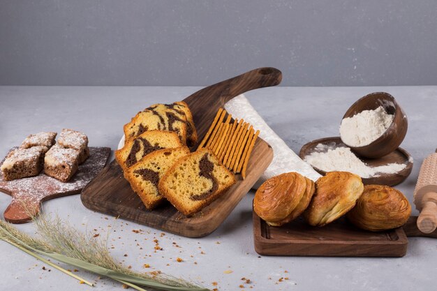 Variety of pastries and crackers on a wooden board