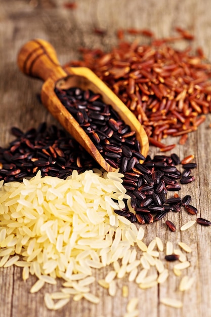 Variety of rice on a wooden background