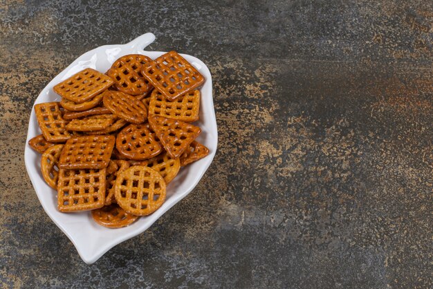 Variety of salted crackers on leaf shaped plate.