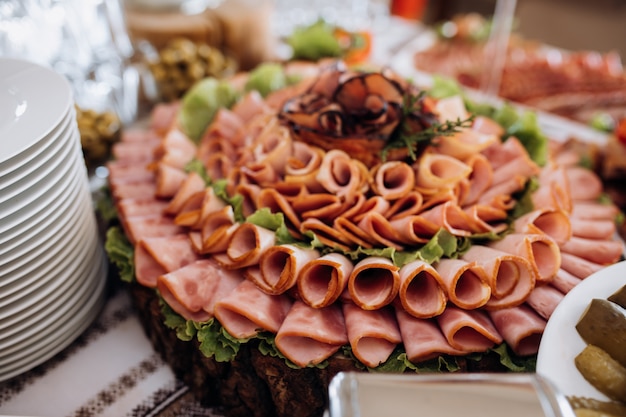 Variety of sliced ham and decorated with salad