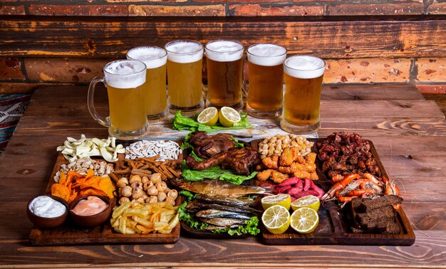 Variety of snacks and nuts with beer cups